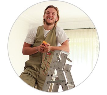 an electrician stands on a ladder to upgrade to LED